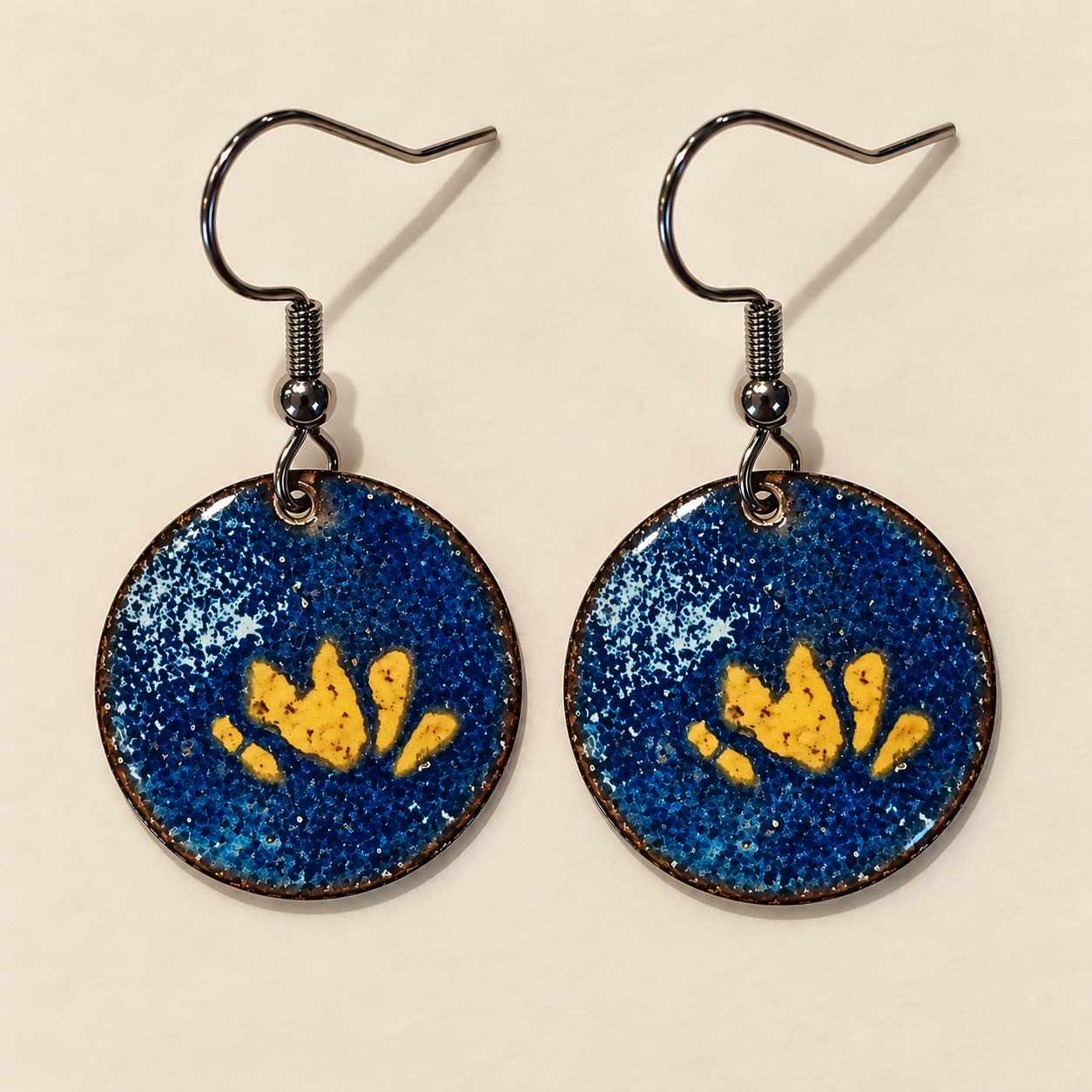 Aretes de cobre esmaltado en azul con un loto amarillo